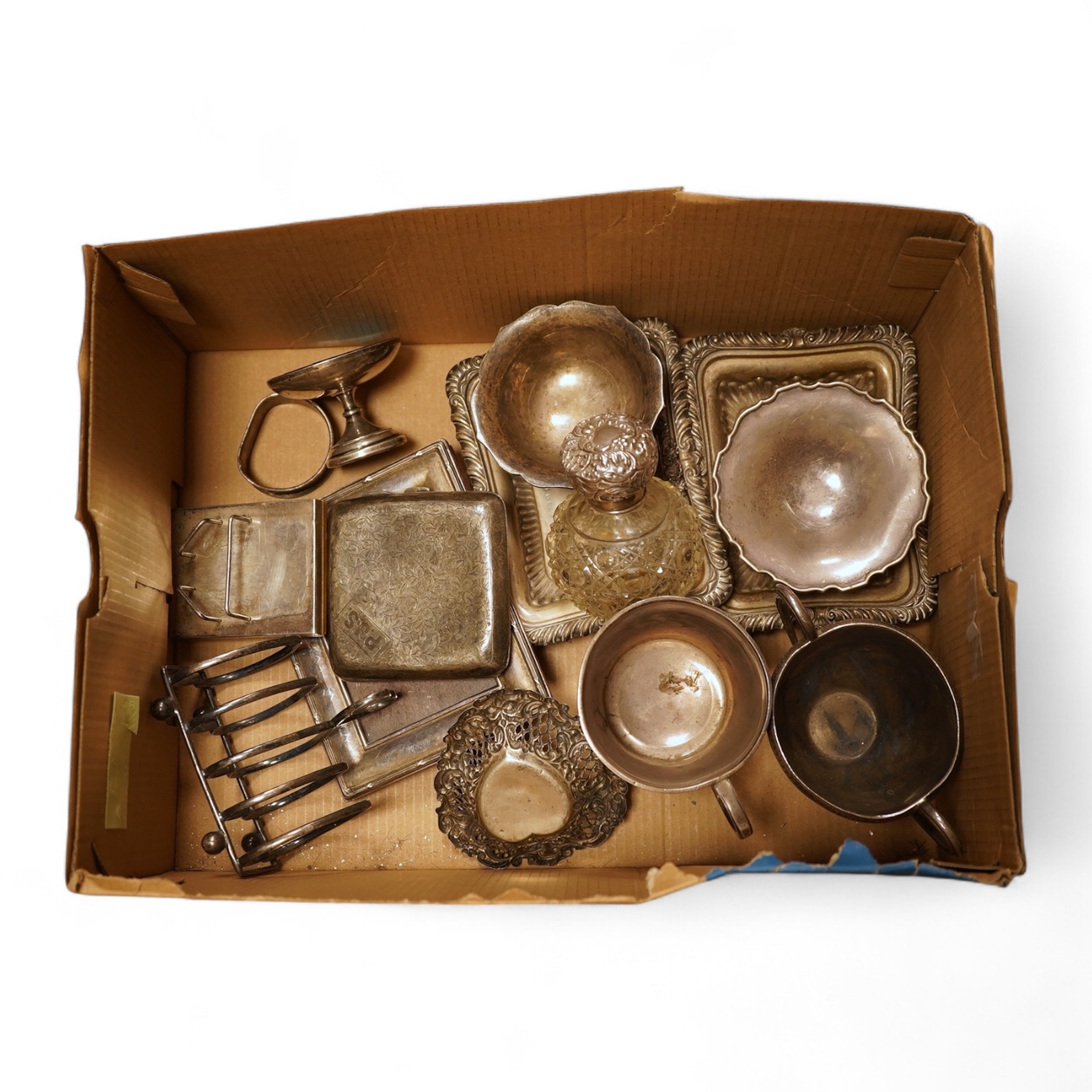 A collection of small silver including a pair of Edwardian rectangular dishes, Thomas Woolley, Birmingham, 1901, 13.2cm, a mug, two handled cup, cigarette case, photograph frame, toast rack, wine label, sovereign case et
